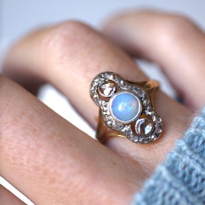 Marquise antique opal ring surrounded by diamonds in pink gold and silver