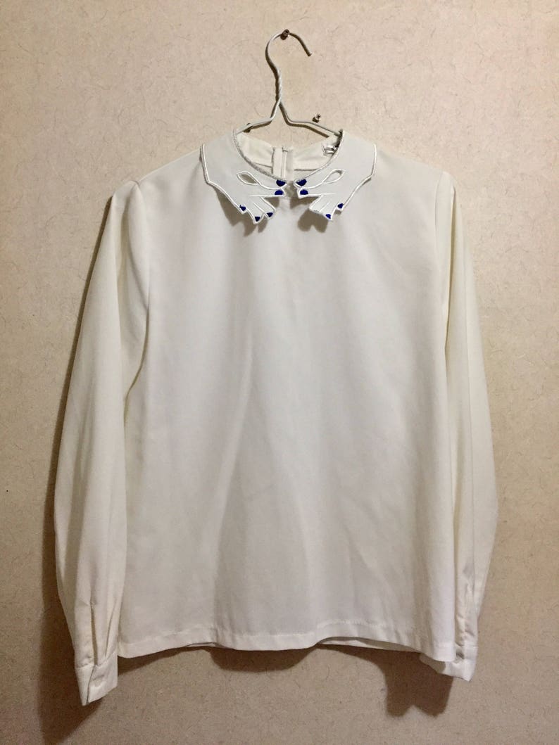 Fingers gesture with purple nail polish on blouse rare