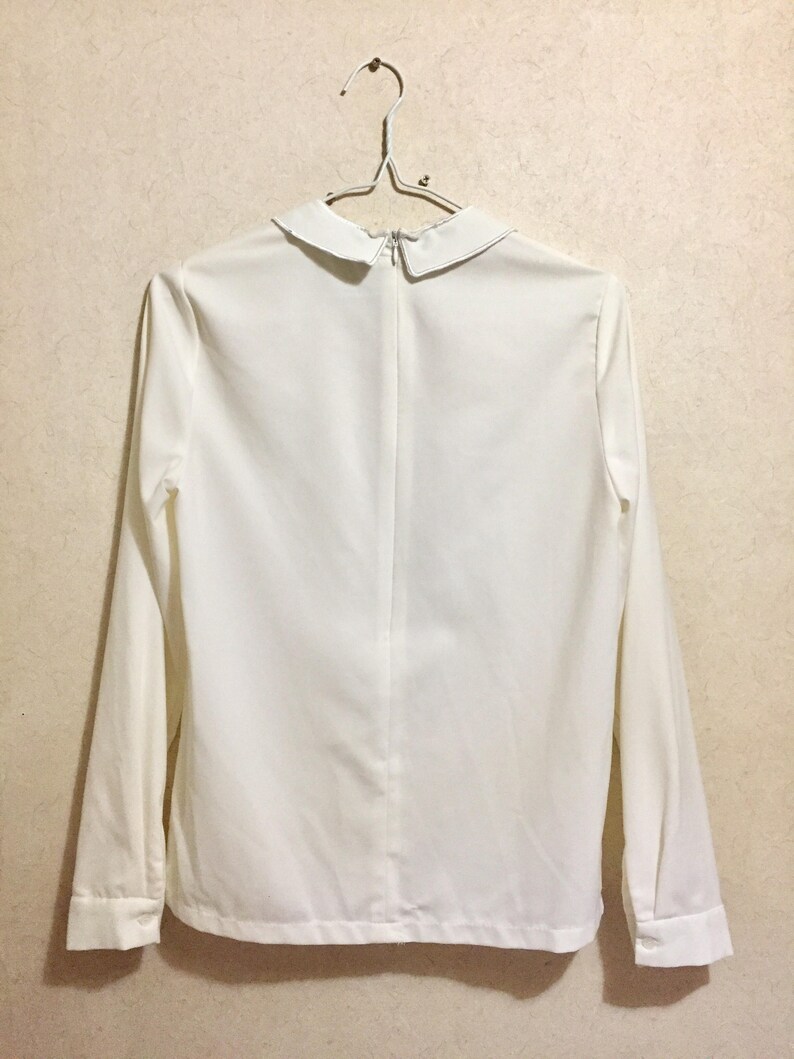Fingers gesture with purple nail polish on blouse rare