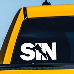 May include: A white vinyl decal with the word "SIN" in large letters. The "I" is replaced with the outline of the state of Nevada.