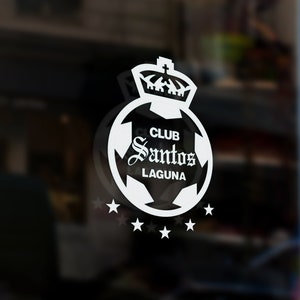 May include: White logo on a glass door with a soccer ball, crown, and the text "Club Santos Laguna".