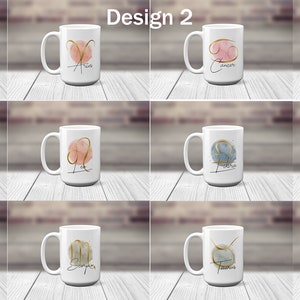 May include: Twelve white ceramic mugs with gold zodiac symbols and watercolor backgrounds. Each mug features a different zodiac sign, including Aquarius, Aries, Cancer, Capricorn, Gemini, Leo, Libra, Pisces, Sagittarius, Scorpio, Taurus, and Virgo.