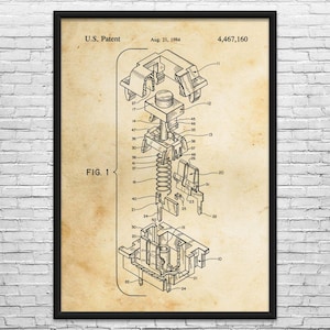 May include: Framed patent diagram of a mechanical keyboard switch, dated August 21, 1984. The diagram, labeled "FIG. 1," shows an exploded view of the switch's internal components, including springs and housing. The patent number is 4,467,160. The print is on a tan background.