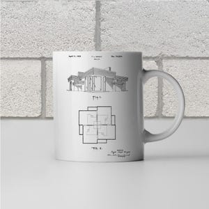 May include: White ceramic mug with a black and white illustration of a house design patent. The patent is for a house designed by Frank Lloyd Wright. The patent number is 1,164,204 and the date is April 11, 1915.