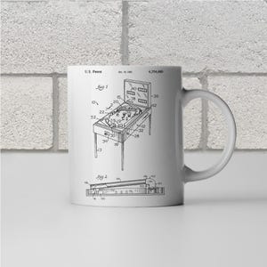 May include: A black and white line drawing of a pinball machine patent. The patent number is 4,354,680. The drawing shows the pinball machine with a flipper, bumpers, and a ball.