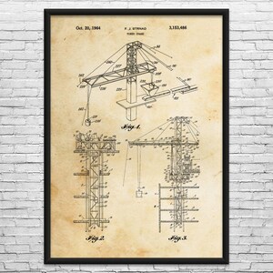 May include: Framed vintage blueprint of a tower crane, dated October 20, 1964, with the name F. J. Strnad and patent number 3,153,486. The blueprint features detailed technical drawings of the crane's components, including diagrams labeled Fig. 1, Fig. 2, and Fig. 3.