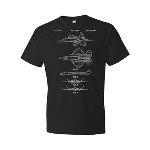 May include: Black t-shirt with a white print of a US patent design for a fighter jet. The patent number is Des. 332,080. The design shows five different views of the jet.