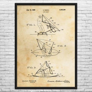 May include: A framed patent print on aged paper featuring technical line drawings of a kite board. The document includes the text July 15, 1969, H. Perrin, Kite Board, 3,455,261, Fig. 1, Fig. 2, Fig. 3, Hugh Perrin Inventor, and Cameron, Kerkam & Sutton Attorneys.