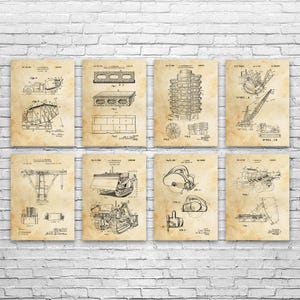 May include: Eight vintage-style prints featuring construction equipment blueprints. The prints are on aged paper, showcasing detailed line drawings of various machines, including a concrete mixer, bulldozer, and crane. The prints are displayed against a white brick wall.