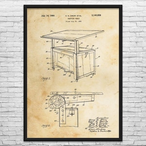 May include: A framed vintage patent illustration of a drafting table, dated July 14, 1964. The drawing shows the table's design with detailed views and labels. The frame is black, and the background is a sepia tone.