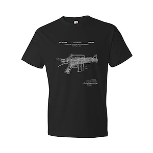 May include: Black t-shirt with a white print of a firearm patent drawing. The patent number is 3,234,189 and the date is Feb. 22, 1966.