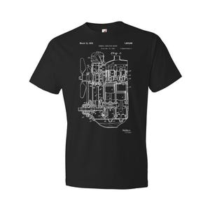 May include: Black t-shirt with a white print of a patent drawing for an internal combustion engine. The patent number is 1,883,093 and the date is March 12, 1933.