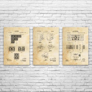 May include: Three vintage patent prints displayed against a white brick wall. The prints feature detailed technical drawings and diagrams, with a sepia-toned background. The prints are framed and ready to hang.