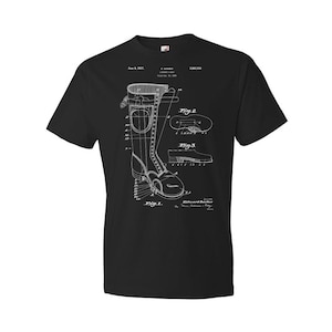 May include: Black t-shirt featuring a white diagram of a tall boot, including detailed schematics and annotations. The design resembles a patent illustration, showcasing the boot's construction and components. The shirt's design includes the date June 8, 1937.