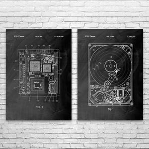 May include: Two framed patent prints. The left print shows a detailed diagram of a circuit board, labeled "FIG. 1" and "U.S. Patent". The right print depicts a hard drive schematic, also labeled "FIG. 1" and "U.S. Patent". Both are in white on a black background.