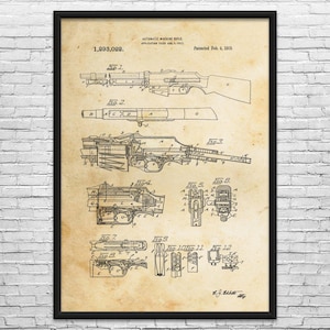 May include: A framed vintage patent print of an automatic machine rifle, dated February 4, 1919. The print features detailed technical drawings and diagrams of the rifle's components, with the patent number 1,293,022.