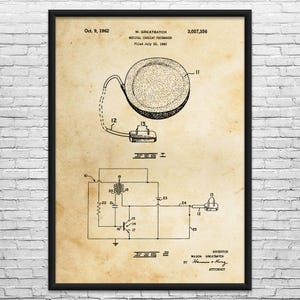May include: Framed vintage patent print of a medical cardiac pacemaker, dated October 9, 1962. The print features detailed diagrams and text, including the inventor's name, Wilson Greatbatch, and patent number 3,057,356.