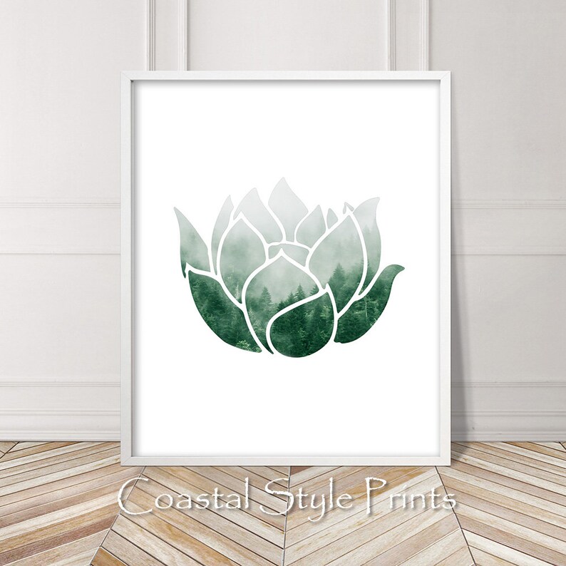 May include: A white framed print with a green watercolor lotus flower design. The lotus flower is filled with a foggy forest scene.
