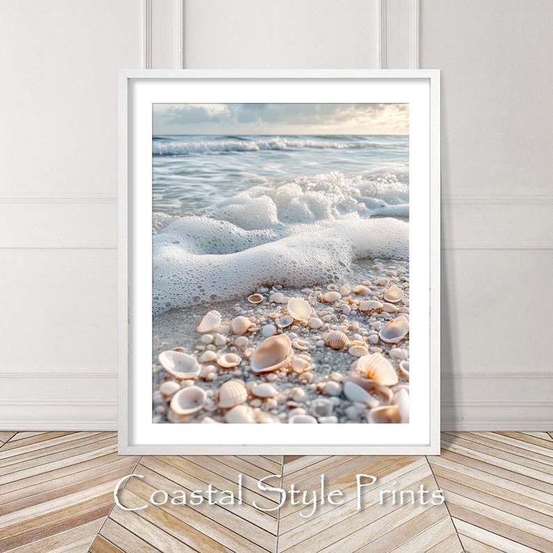 May include: A close-up of a sandy beach with white foamy waves crashing on the shore.  Seashells of various sizes and shapes are scattered on the sand.