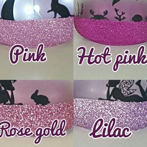 May include: Four glass jars with different colored glitter on the rim. The colors are pink, hot pink, rose gold, and lilac. Each jar has a different design on the front.