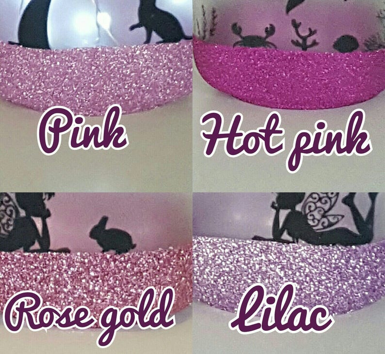May include: Four glass jars with different colored glitter on the rim. The colors are pink, hot pink, rose gold, and lilac. Each jar has a different design on the front.
