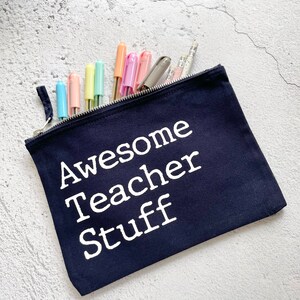 May include: A dark blue canvas zippered pouch with the text "Awesome Teacher Stuff" printed in white.