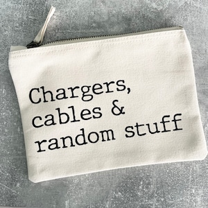 May include: A white canvas zippered pouch with the text "Chargers, cables & random stuff" printed in black.