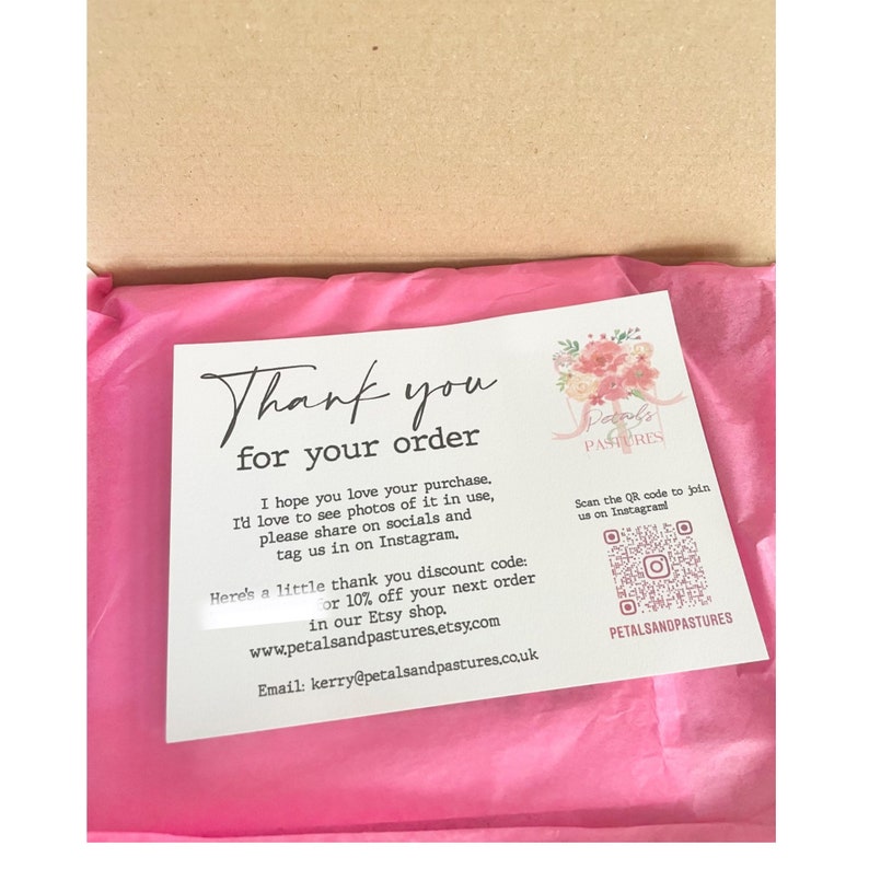 This photo shows the pouch wrapped up in its parcel box in pink tissue paper with a thank you slip on top.