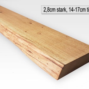 Op de afbeelding: Een lange, natuurlijke houten plank met een ruwe rand. De plank is 2,8 cm dik en 14-17 cm diep.