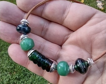 Handmade Lampwork / Torchwork Glass Bead Necklace in Transparent and Opaque Greens on Natural Leather Cord - Studio Glass - Art Glass