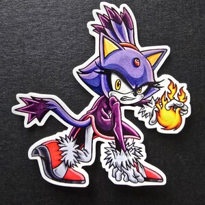 May include: A sticker featuring a stylized cartoon character with purple and blue fur, wearing a purple outfit and red shoes. The character is holding a ball of fire in its hand, with a determined expression.