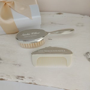 May include: A silver baby hair brush and comb set with the inscription "Amelia Willow Happy 1st Birthday" on the brush and "Love from Auntie Kate X" on the comb.