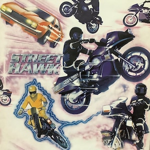May include: A vintage poster featuring the title "STREET HAWK" in bold white letters. The poster features a colorful illustration of motorcycles and cars speeding through a white background with pink and blue streaks.
