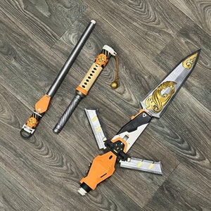 May include: Three fantasy weapons, including a staff with a leather strap, a sword with a gold and black handle, and a dagger with a gold and black handle.