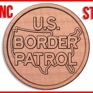 May include: A round, wooden plaque with a brown finish. The plaque features a raised outline of the United States with the text "U.S. BORDER PATROL" inside.