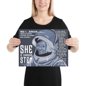 May include: A rectangular poster featuring a stylized illustration of Mae C. Jemison in a space helmet. The text includes her biography, the phrase "SHE IS CHANGING STEM," and details about her career as an engineer, physician, and astronaut.