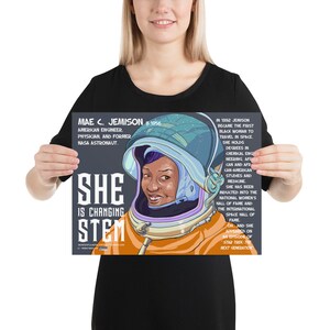 May include: A poster featuring Mae Jemison, the first Black woman to travel in space. The poster has a dark gray background with a colorful illustration of Jemison in a space suit. The text on the poster reads "She is changing STEM" and includes biographical information about Jemison.