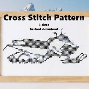 May include: Cross stitch pattern of a snowmobile in black, white, and grey, framed in a light wood. The text "Cross Stitch Pattern" and "3 sizes Instant download" are displayed above the snowmobile image.