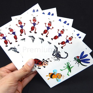 May include: A set of six white cards with colorful insect illustrations. The cards feature ants, a ladybug, a scorpion, a grasshopper, a dragonfly, and a bee. The cards are perfect for a craft project or for playing a game.