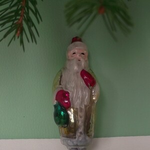 Cute Santa Claus. Adorable St. Nicholas with Gifts.  Antique Christmas Tree Glass Decoration