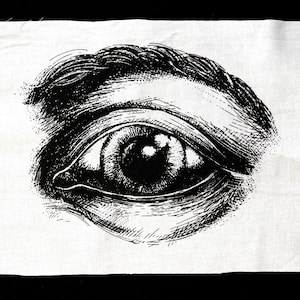 Puede incluir: Una ilustración en blanco y negro de un ojo humano sobre un fondo de tela blanco.