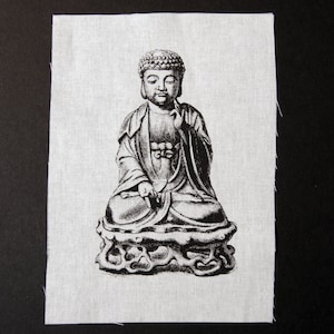 May include: Black and white illustration of a seated Buddha statue with a serene expression. The statue is depicted wearing traditional robes and is sitting on a lotus base.