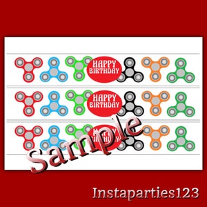 May include: A white sheet with rows of colorful fidget spinners in red, blue, green, black, and orange. The words "Happy Birthday" are in a red circle. The word "Sample" is across the image.