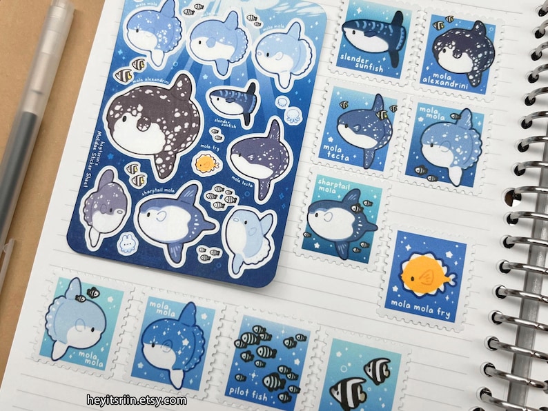Peut inclure: Une feuille d'autocollants de poissons-lunes et des timbres individuels. Les autocollants et les timbres pr&eacute;sentent divers motifs de poissons-lunes dans des tons de bleu, blanc et noir. Les timbres incluent du texte tel que "mola alexandrini" et "mola mola fry".