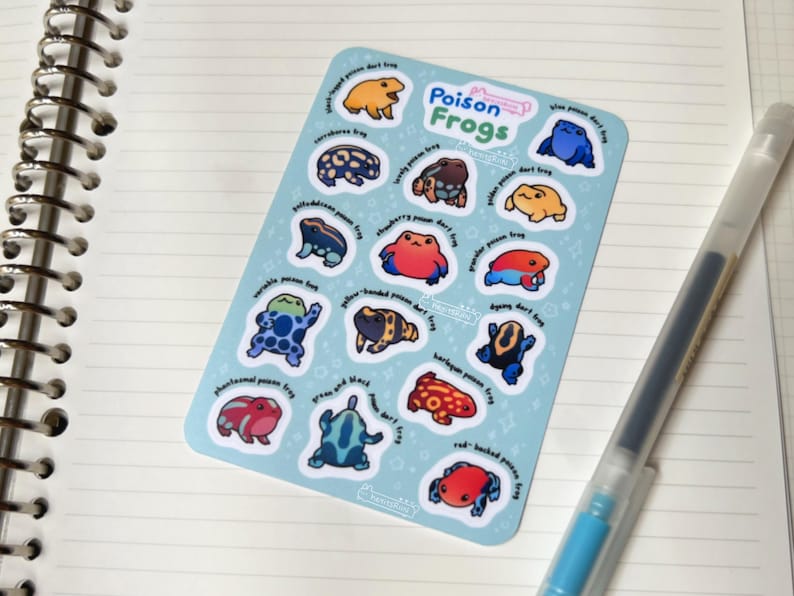 Poison Frogs matte sticker sheet. Contains the following frogs: black-legged poison dart frog, blue poison dart frog, corroboree frog, lovely poison frog, golden poison dart frog, Golfodulcean poison frog, strawberry poison dart frog, granular poison frog, variable poison frog, yellow-banded poison dart frog, harlequin poison frog, dyeing dart frog, phantasmal poison frog, green and black poison dart frog, red-backed poison frog.