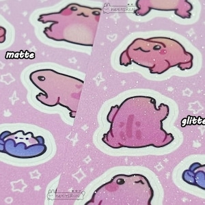 May include: Pink frog stickers with glitter and matte finishes. The stickers have a pink background with white stars and the words "matte" and "glitter" printed on them.