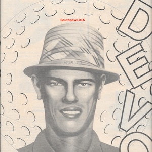 May include: Black and white image featuring a stylized portrait of a man wearing a fedora hat. The image includes the text "Q: ARE WE NOT MEN? A: WE ARE DEVO!!!" and "the important sound of things falling apart."