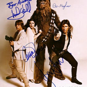 May include: A group photo featuring characters from Star Wars, including Chewbacca, Han Solo, Princess Leia, and Luke Skywalker. The image has several signatures in blue ink. The text "DO NOT COPY" is visible at the bottom.