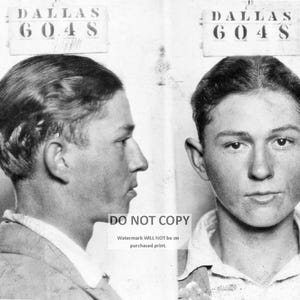 May include: Black and white mugshot of a young man with short hair. The mugshot is labeled "DALLAS 6048" at the top.