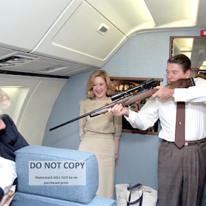 President Ronald Reagan Aiming a Rifle Aboard Air Force One in November, 1985 - 5X7, 8X10 or 11X14 Photo (RT-784)